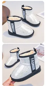 Close-up detail of sparkly rhinestone kids' snow boots featuring warm faux fur lining.