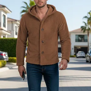 Detail of men's warm brown coral fleece hooded jacket with buttons in outdoor setting