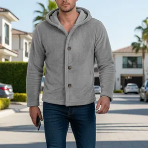 Man wearing grey coral fleece hooded jacket with buttons in outdoor street setting