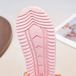 Macro view showing the pink non-slip rubber sole pattern of girls winter snow boots