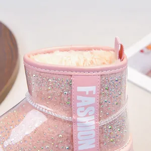 Close-up of pink girls snow boots with sparkly rhinestones and warm faux fur lining