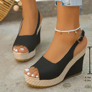 Detailed view of black peep-toe wedge sandals showing the 9.9cm high platform heel