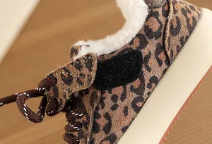 Detailed view of leopard print kids' winter sneakers with warm fleece lining and laces