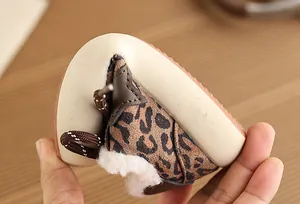 Detailed view of flexible sole and plush lining on leopard print children's sneakers