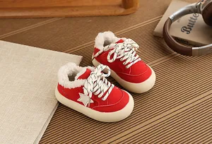 Macro view of warm red children's fleece-lined sneakers with star design and thick sole