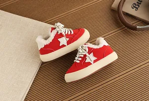 Detailed view of red children's fleece-lined sneakers with white star motif for winter warmth.