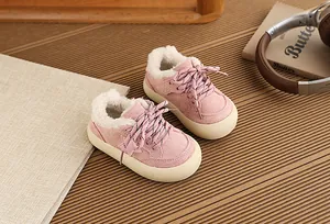 Cozy pink children's sneakers with star pattern and soft faux fur lining for winter.