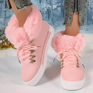 Detail view of pink faux fur trim snow boots for women with thick soles and lace-up design.