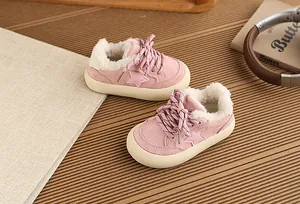 Detailed view of pink kids sneakers featuring warm fleece lining and star pattern detail