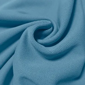 Close-up detail of breathable honeycomb mesh fabric for men's quick-dry golf polo shirt.