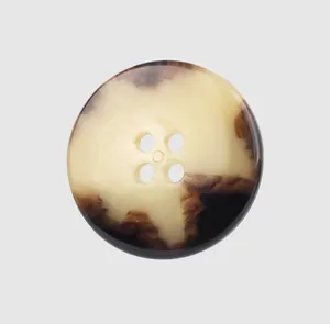Macro detail of high-end urea button with marbled horn-like texture and 4 holes