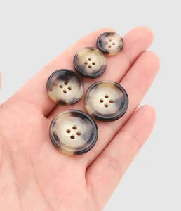 Detail of high-end urea buttons with brown tortoiseshell pattern and 4-hole design