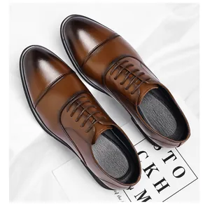 Detailed view of polished brown leather cap-toe Oxford shoes with lace-up design