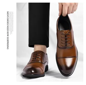 Macro view showing the polished leather and gradient finish of brown men's cap-toe dress shoes
