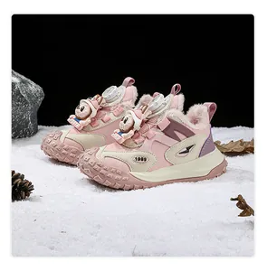 Close-up of pink children's warm winter sneakers with cute cartoon rabbit accessories