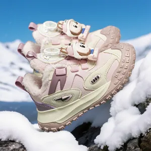 Warm children's pink winter sneakers with fleece lining and cute cartoon details in snow