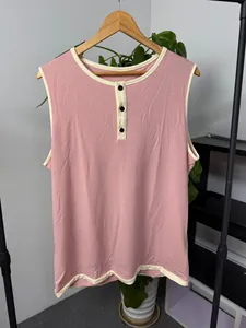 Close-up detail of pink men's Henley sleeveless tank top with contrast cream binding