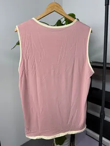 Detailed back view of a pink cotton men's tank top with white contrast ringer trim.