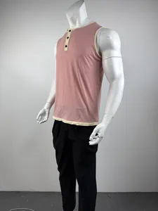 Side view of pink sleeveless Henley tank top with beige contrast trim on mannequin.