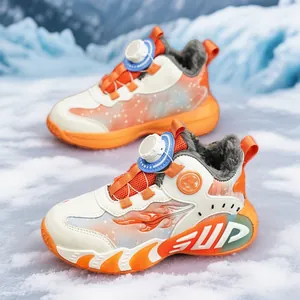 Cozy winter sneakers for boys with orange accents and rotary dial in snow scene