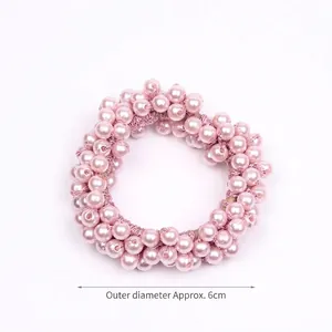 Close-up detail of a pink beaded hair scrunchie showing the outer diameter of 6cm