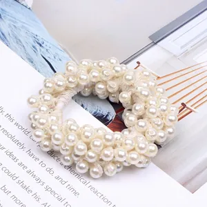 High-quality close-up detail of a stylish white beaded pearl hair tie scrunchie for women