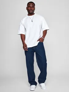 Classic men's straight-leg dark blue denim jeans styled with a white tee and sneakers