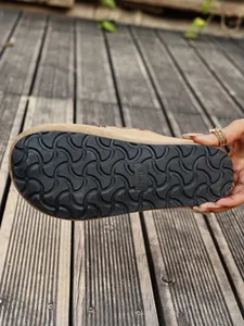 Close-up of the anti-slip outsole on a platform suede clog