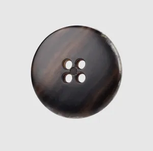 Macro detail of high-end dark brown urea button with natural horn texture and four holes
