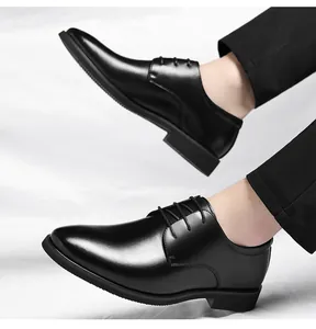 Detailed view of men's black lace-up business formal dress leather shoes on model
