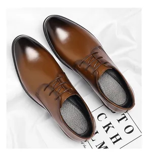 Detailed view of men's brown business dress shoes featuring black gradient toe caps