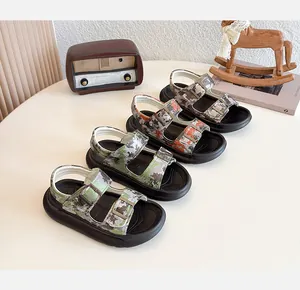 Various colors of kids' breathable camouflage beach sandals displayed on a table