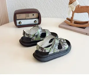 Stylish kids camouflage sandals with thick black soles and adjustable metal buckles detail.