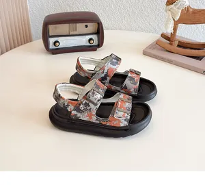 Close-up of children's camouflage sandals with dual buckle straps and soft sole