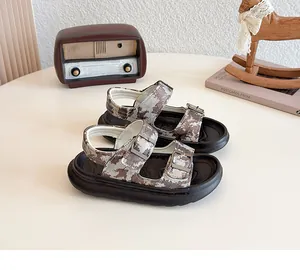 Detail view of camouflage print children's sandals with adjustable double buckle straps