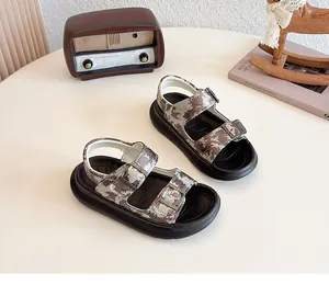 Close-up of children's camouflage sandals with adjustable buckles and thick black soles