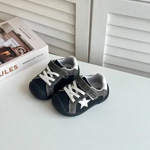 Close-up of baby walking shoes with star detail and adjustable straps