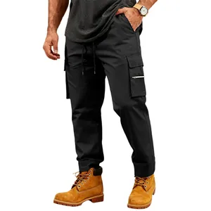 Detail view of men's loose black cargo sweatpants with multiple pockets and drawstring