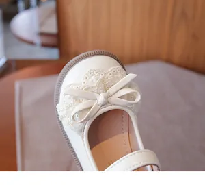 Primer plano de encaje y lazo en zapato tipo Lolita color crema para niña