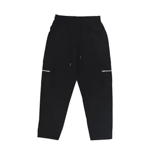 Close-up detail of men's loose black cargo sweatpants featuring functional zipper pockets