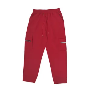 Red cargo sweatpants with multi-pockets and drawstring waist in loose street style.