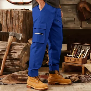 Detail of blue men's tactical cargo pants with multiple pockets in workshop setting