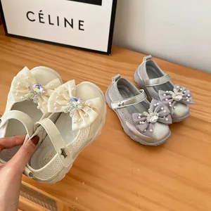 Close-up of girl's breathable mesh princess shoes with rhinestone bow details