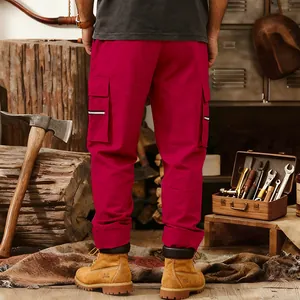 Detail view of men's red tactical cargo pants with large pockets and reflective strips