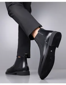Close-up view of a men's black leather Chelsea boot detailing the sole and side profile design