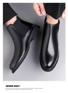 Close-up of black men's leather Chelsea boots showing sleek pointed toe and smooth finish