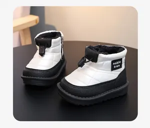 Detail view of waterproof black and white children's snow boots with warm plush lining