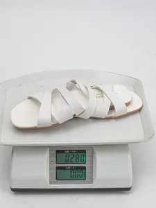 Detailed view of lightweight white women's flat slide sandals weighing 0.280 kg on scale