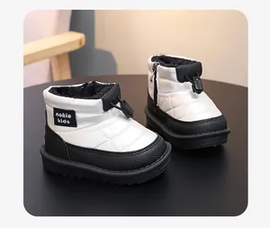 Detail view of children's waterproof fleece-lined snow boots in black and white