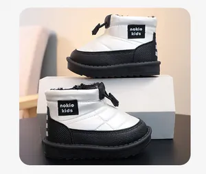Detail of white and black waterproof snow boots for kids with warm plush lining